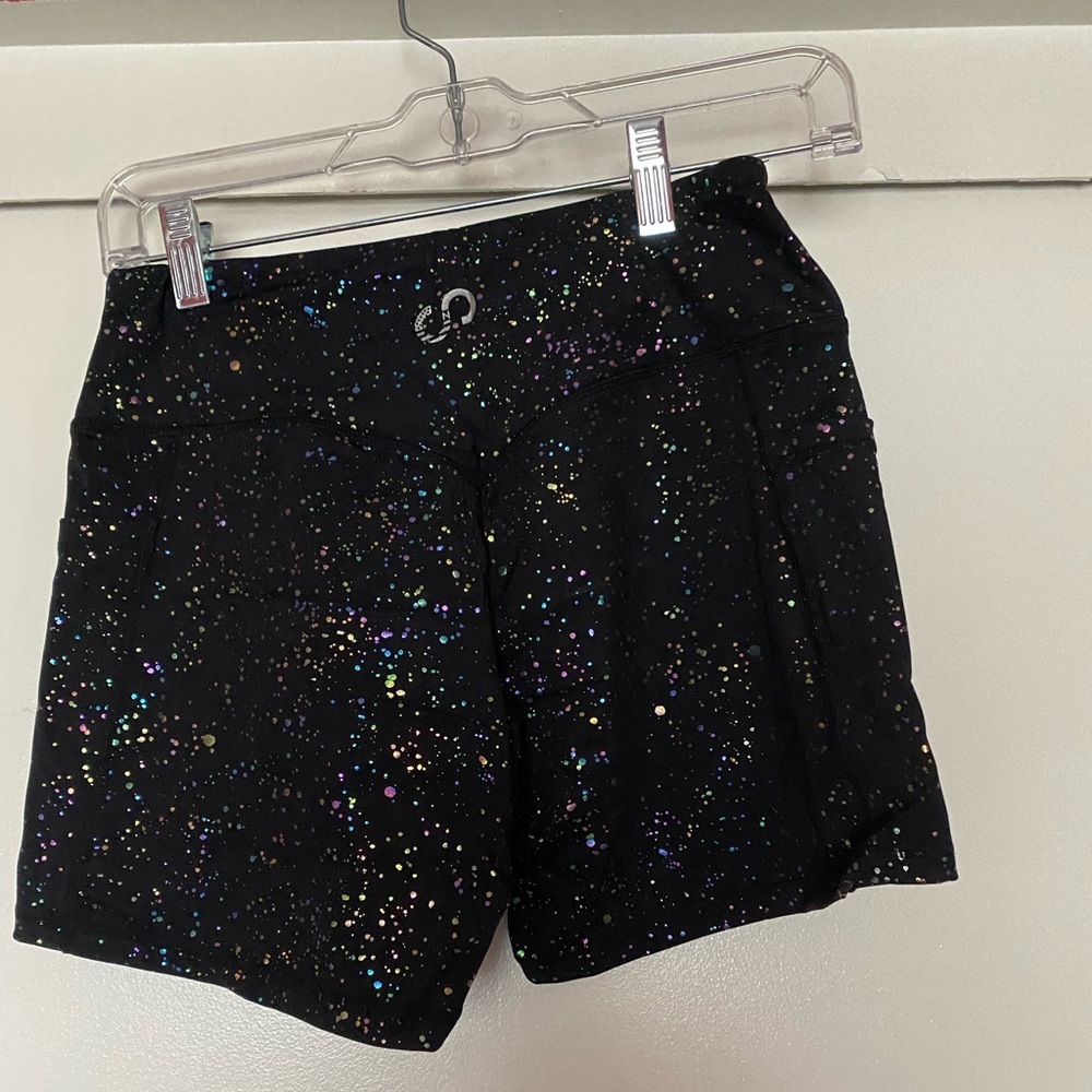 Empowered rainbow splatter shorts.